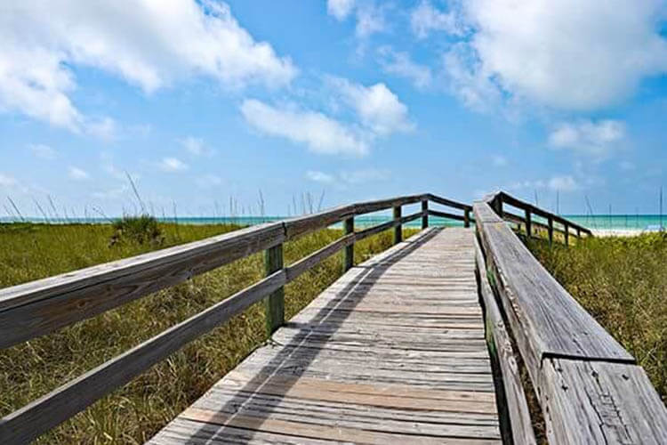 Wooden Beach Boardwalk leading to the white sandy Anna Maria Island, Florida