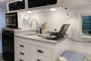 dual stove top with kitchen sink and storage