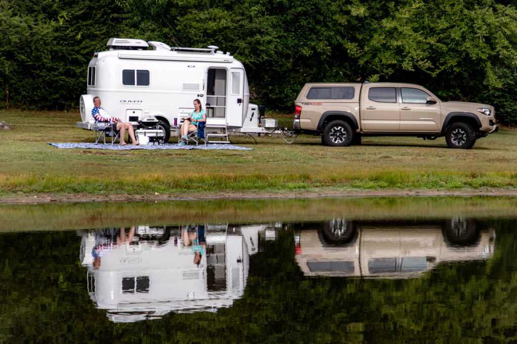 Couple Camping with their Oliver beside a lake
